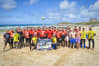A large stag group participating in a cornish beach games activity
