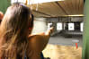 A woman firing a pistol