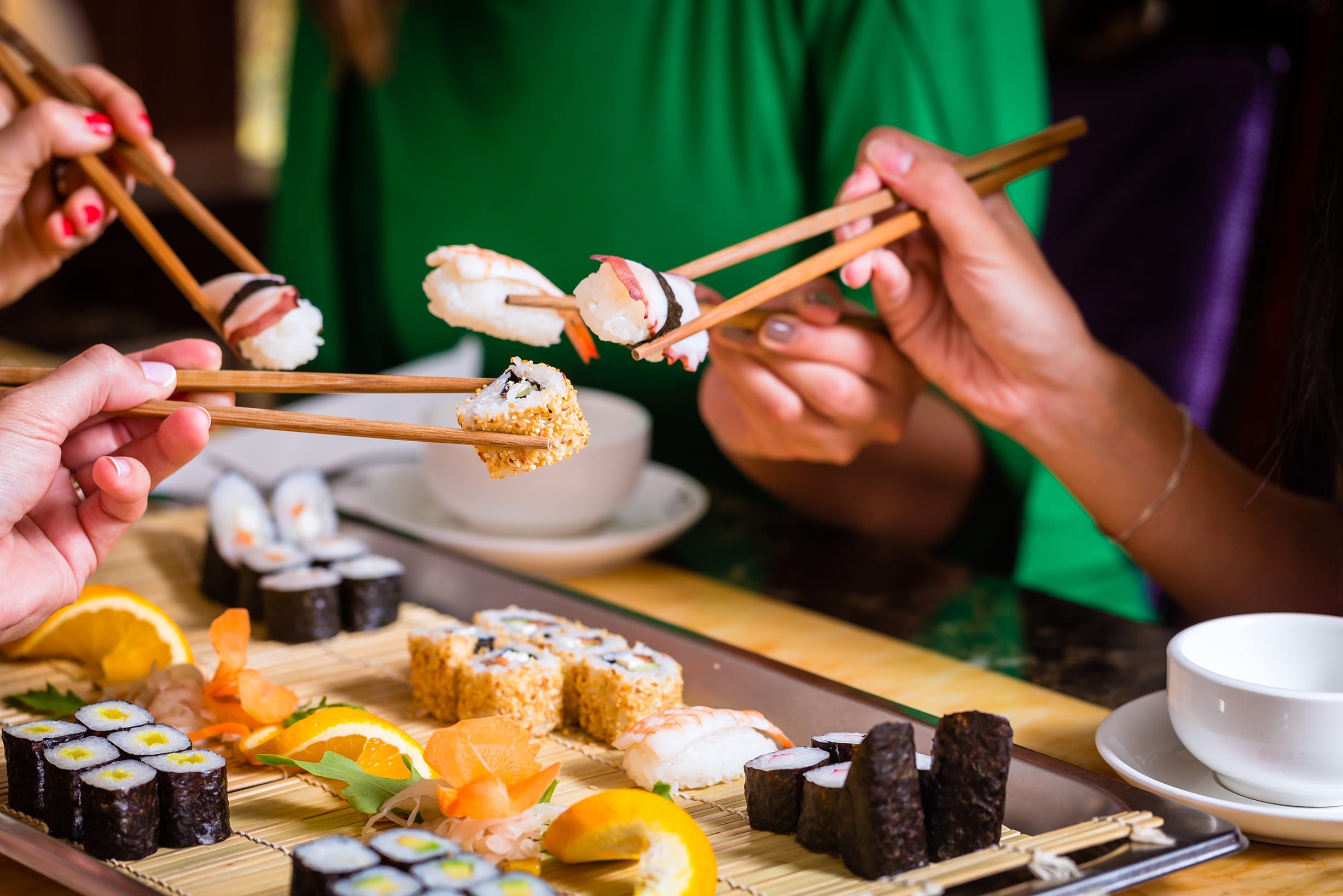 friends enjoying sushi together