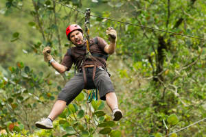 A man having fun on a high ropes course