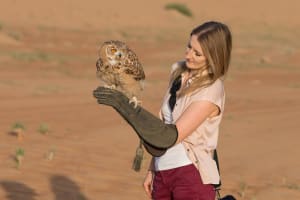 woman holding an owl falconry