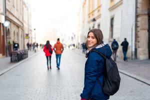 Young woman tourist in the city of Krakow , Poland, visiting the city.