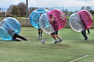 A laughing stag group play zorb footballl