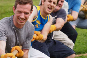 A group of men playing tug of war flipped image