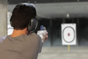 man doing indoor shooting pistol
