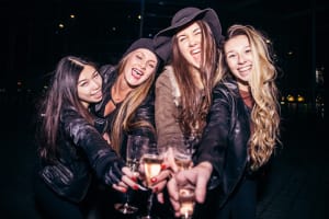 group of women drinking champagne in nightclub VIP aspect