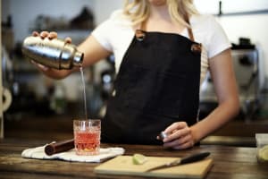 A person having fun during a cocktail making class