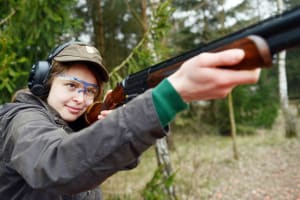 A woman shoots clay pigeons