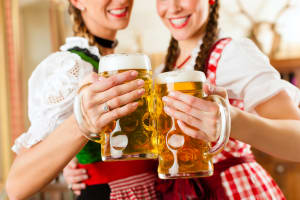 Two women drinking beers in a Bavarian beer house