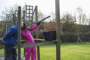 A woman on a hen party doing clay pigeon shooting activity
