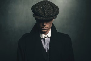Peaky Blinders tour portrait of retro 1920s english gangster with flat cap