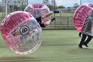 A laughing stag group play zorb footballl