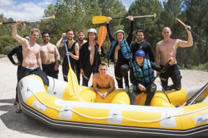A happy stag group doing white water rafting