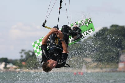 man doing a kite surfing trick