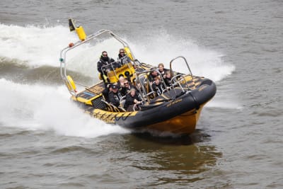 A boat speeding down the river Thames