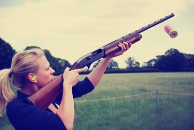 A woman shooting during clay pigeon activity