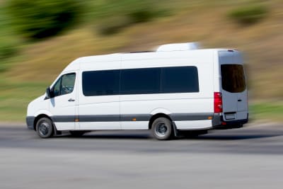 A minibus driving on a road
