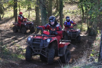 A stag group driving quad bikes through the forrest