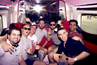 A stag group celebrate in a party bus