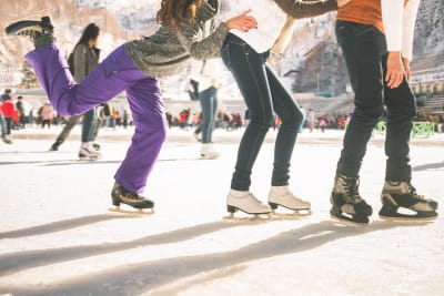three young people enjoying ice skating