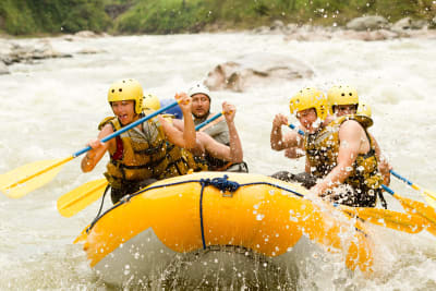 a group of happy people white water rafting