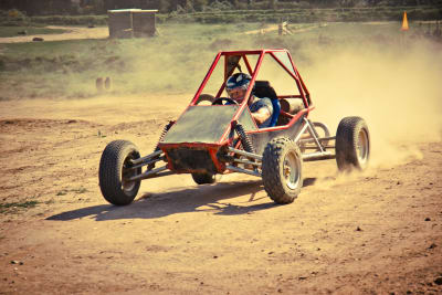 rage buggy dirty buggy off road kart on dusty track