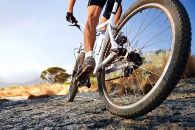 Man riding along a path on a mountain bike