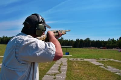 Man shooting gun during clay pigeon event
