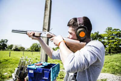 A man clay pigeon shooting
