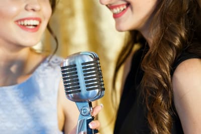 women singing karaoke