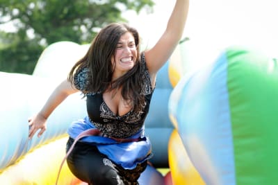 A woman participating in it's a knockout activity