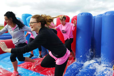 A happy hen group having fun a they participate in it's a knockout activity
